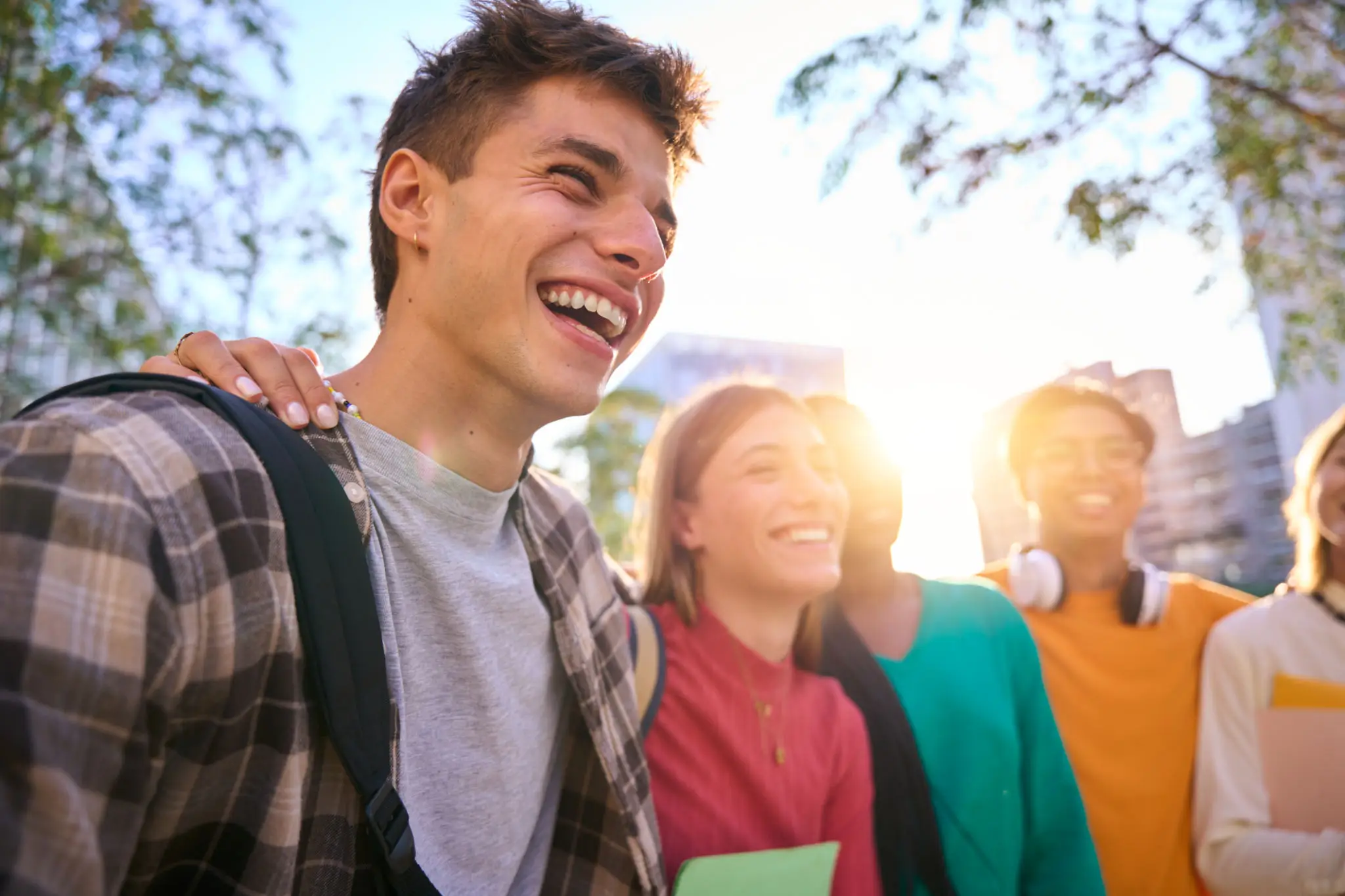 Group of friends enjoying a sunny day outdoors, laughing together.