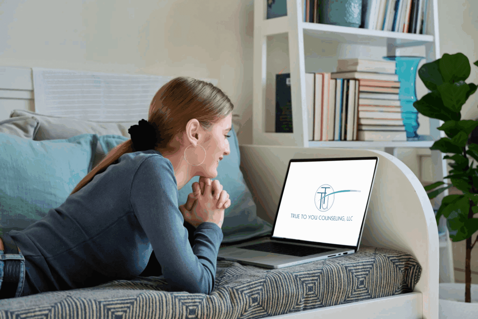 Woman video chatting on a laptop at home.
